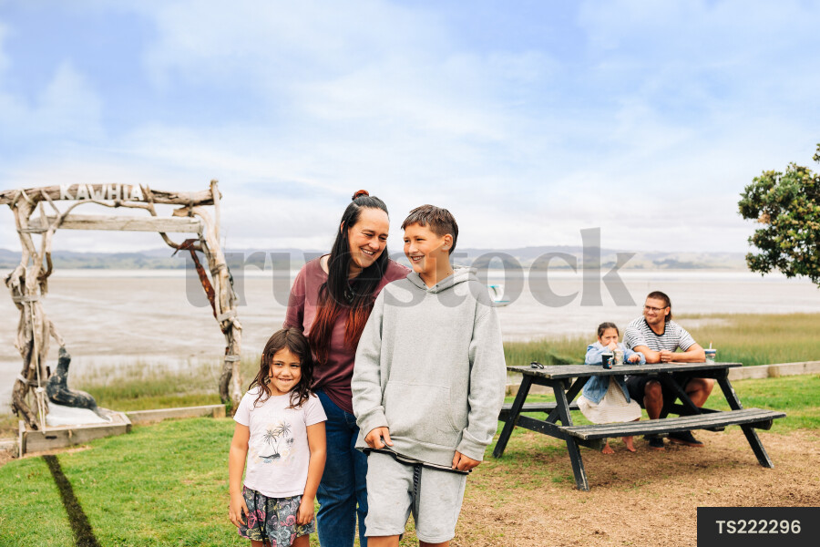 Family by picnic table at beach