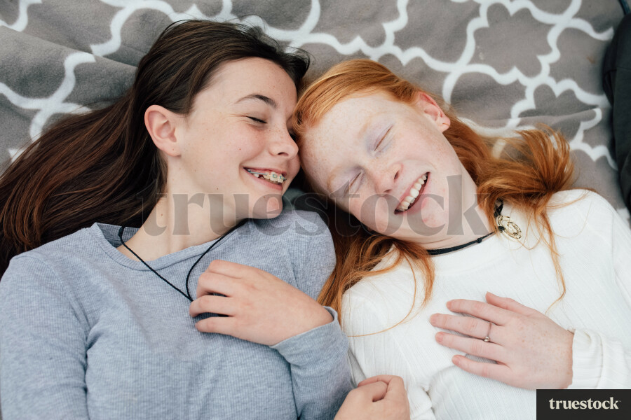 Teen Girls Lying on Blanket in Park