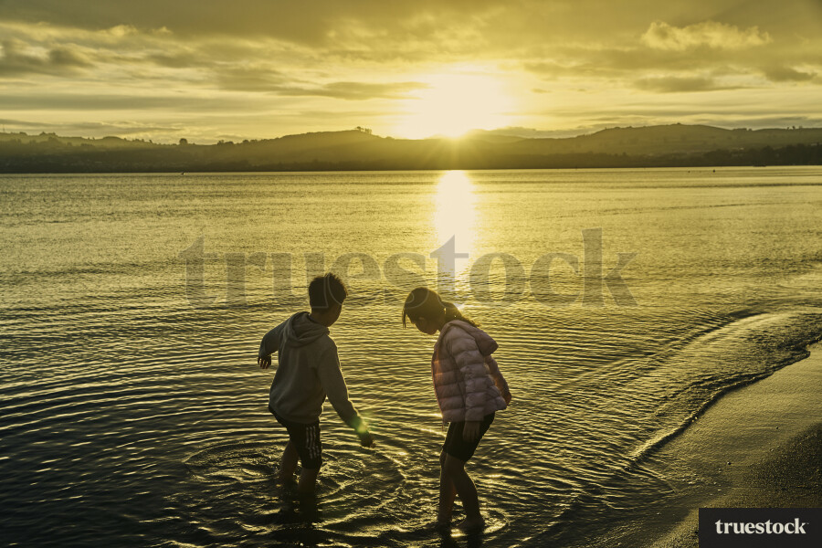Siblings Playing in Ocean