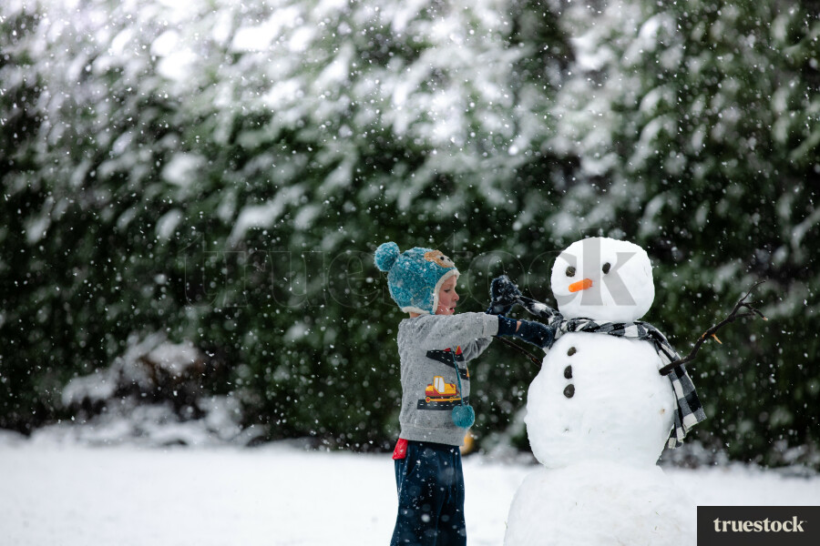 Child building a snowman