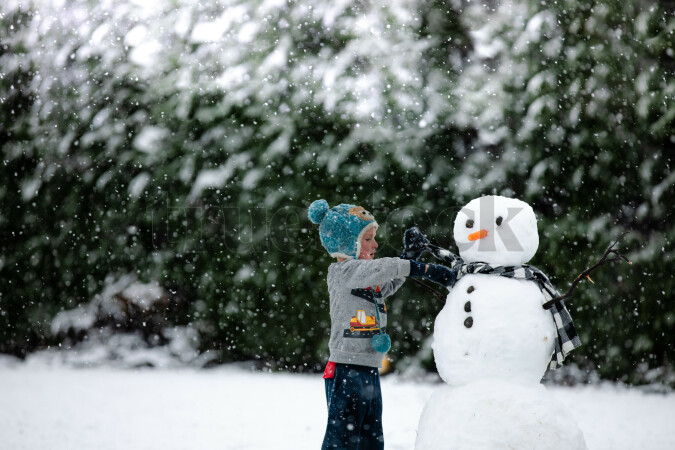 Child building a snowman
