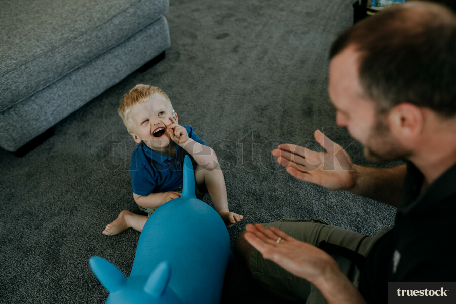 Father doing sign language to toddler