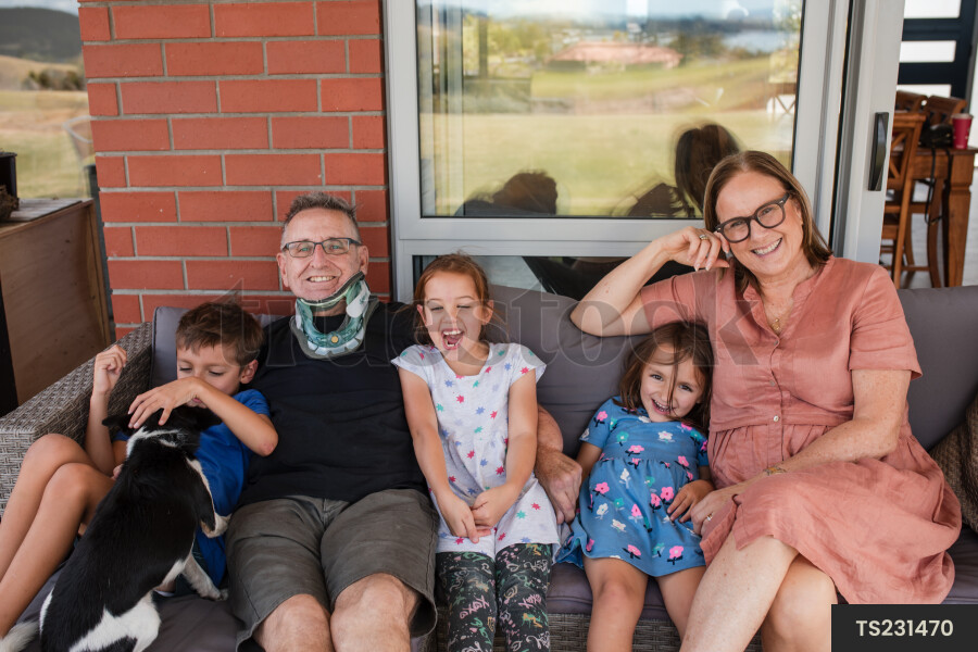 Man and woman sitting with their grandchildren