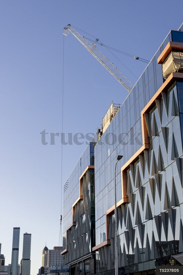 Construction with crane by commercial building