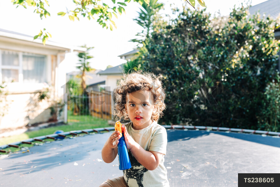 Boy playing on trampoline