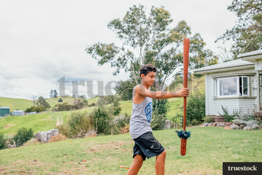 Teenager doing Taiaha in his Backyard