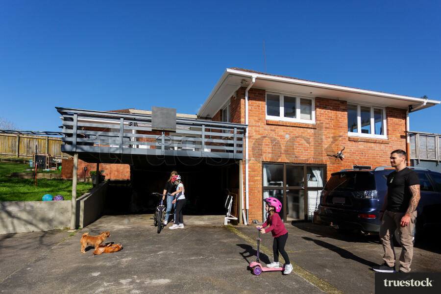 Family Playing on Bikes and Scooters outside home