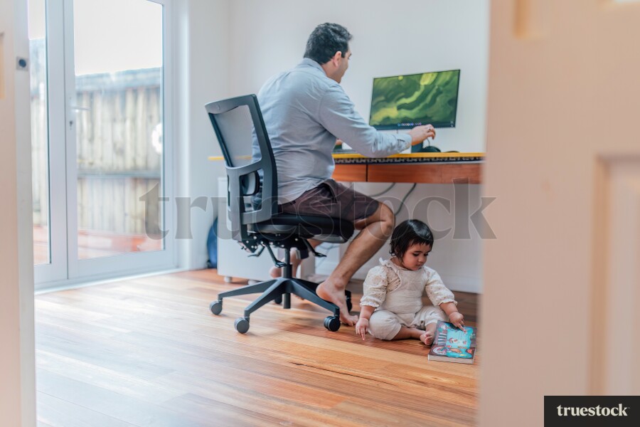 Young Girl With Toy While Dad Works