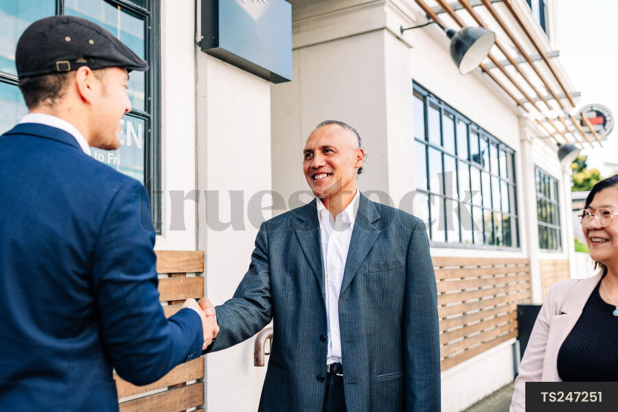 Smiling businesspeople shaking hands
