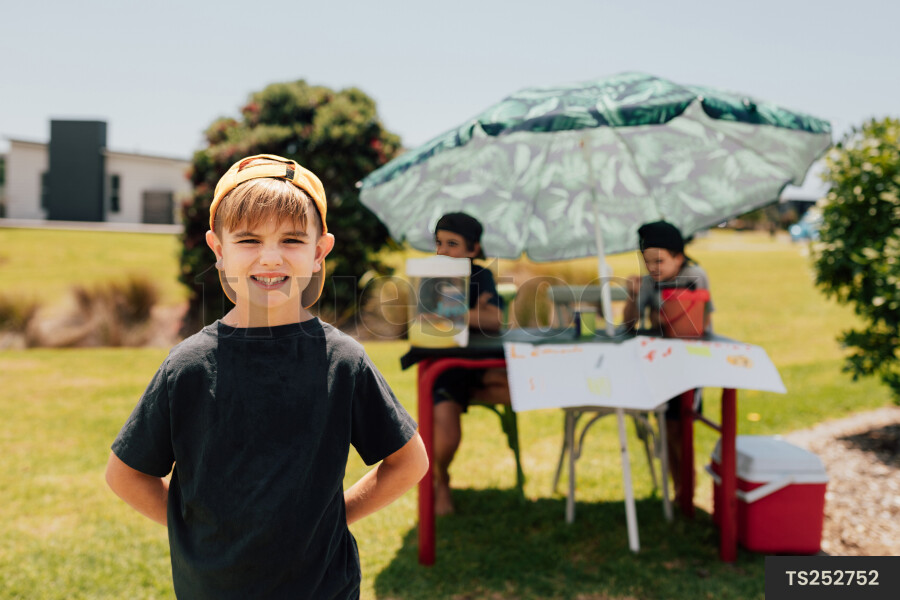 Portrait of Young Boy in Front of Lemonade Stand