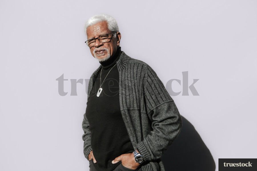 Elderly Māori Man against a Plain Background