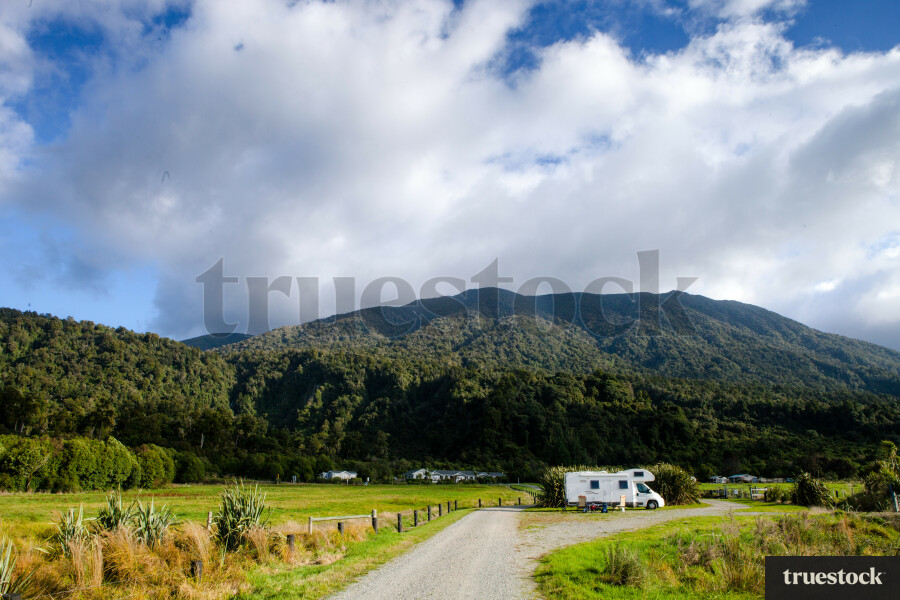 Parked campervan below the mountains