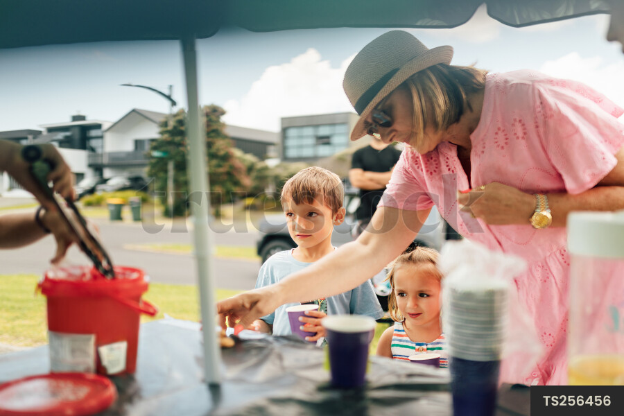 Kids Buying Lemonade at Lemonade Stand