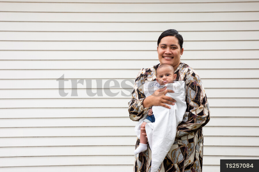 Portrait of tongan mother holding baby boy
