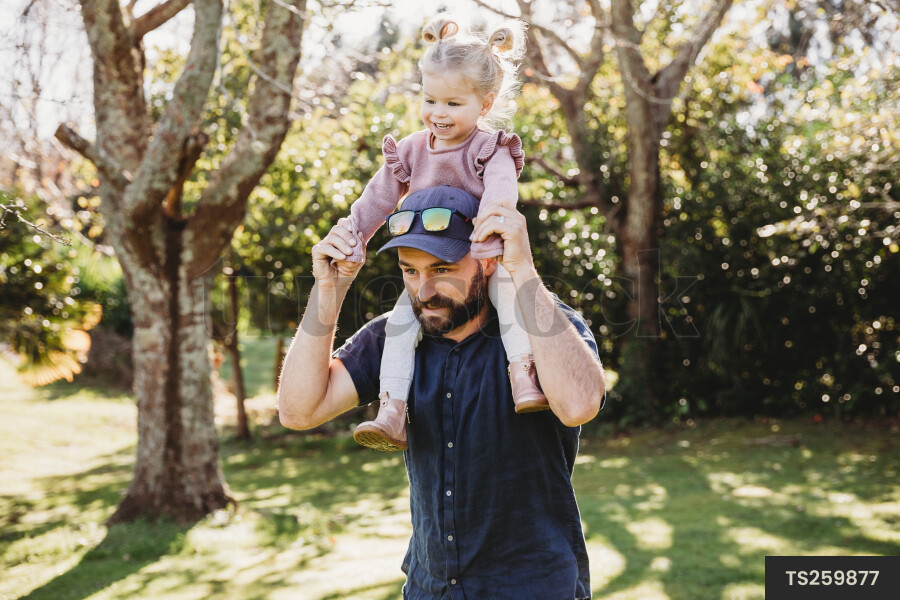 Father Carrying Daughter on Shoulders