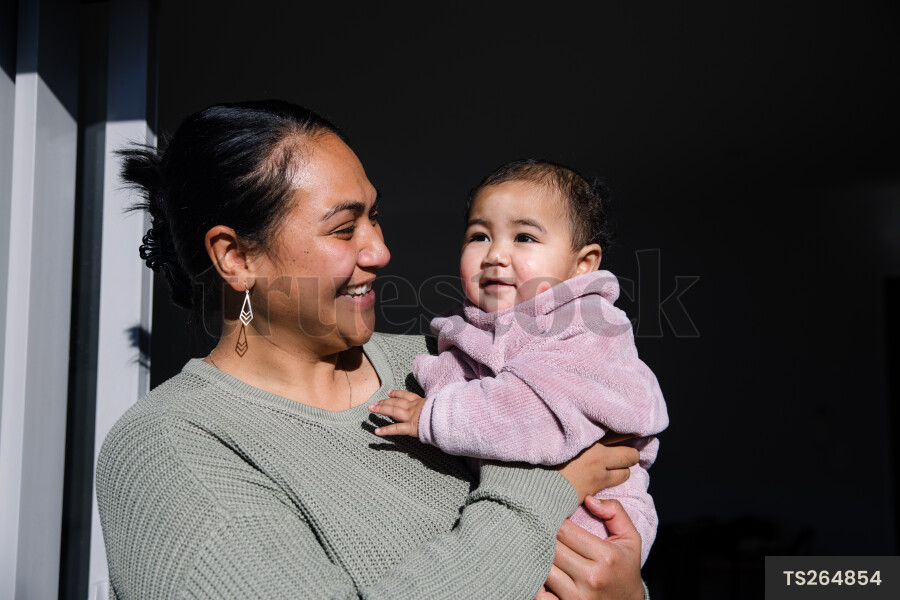 Woman holding baby daughter