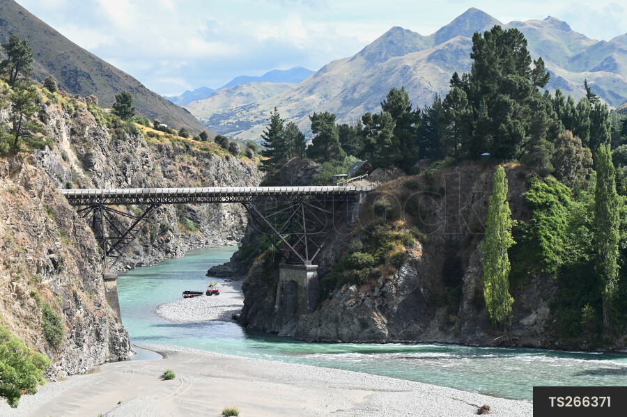 Bridge over river next to mountain range