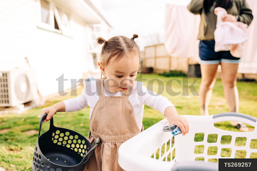 Young Girl Helping with Laundry