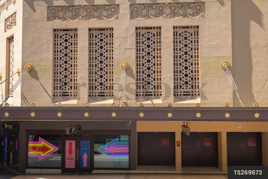 Neon arrow sign in window of building