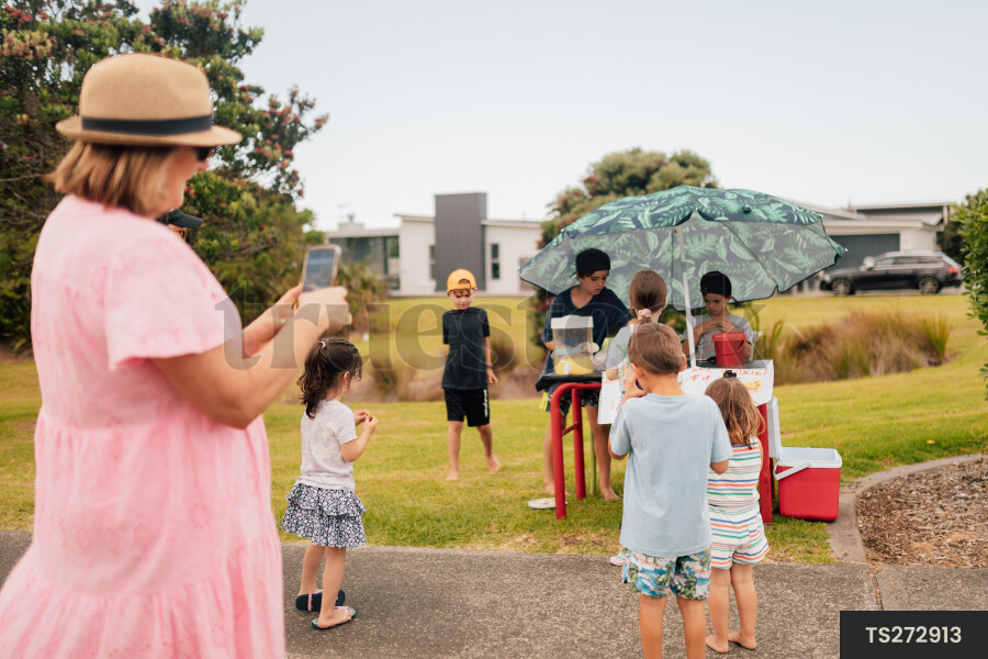 Kids Buying Lemonade at Lemonade Stand