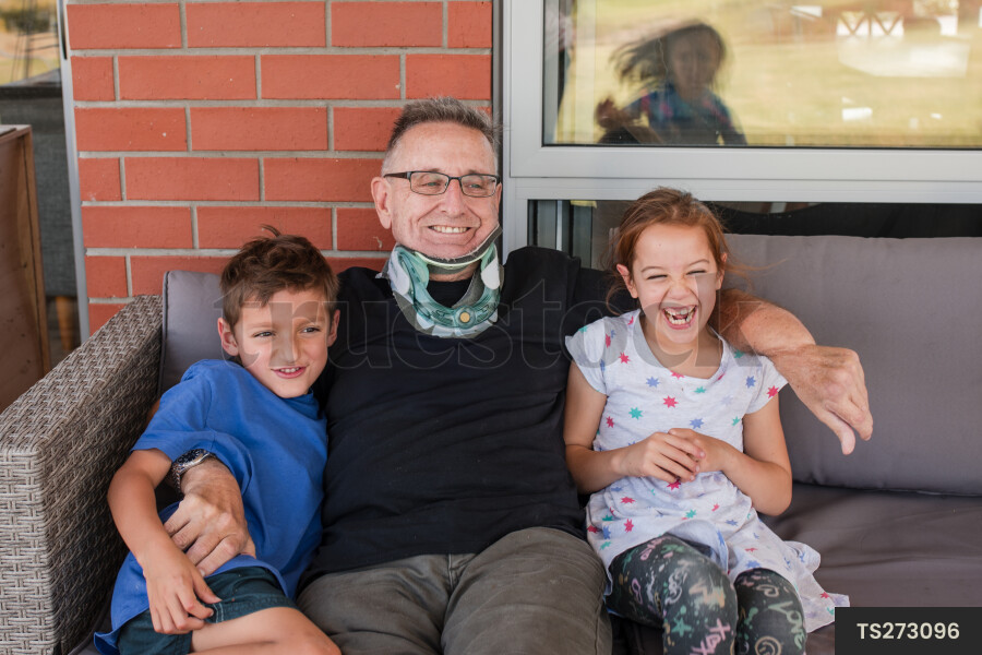 Man sitting with his grandchildren