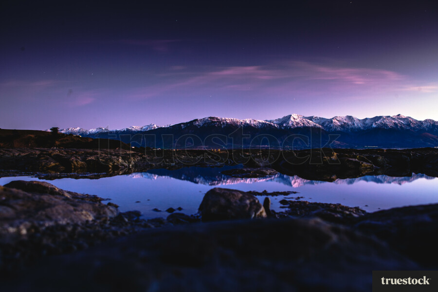 Sunset over the mountain ranges with mountain reflection