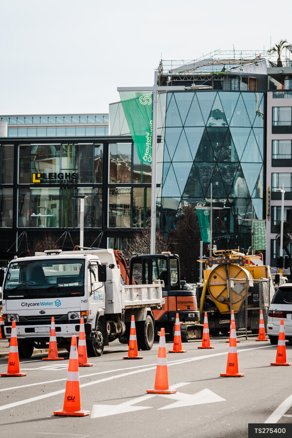 Traffic cones and vehicles at construction site