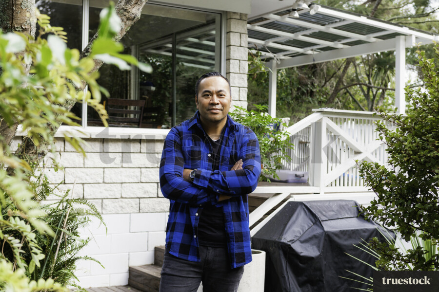 Samoan Man standing outside his Home