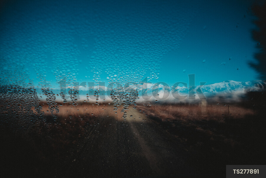 Condensation on window with mountain range