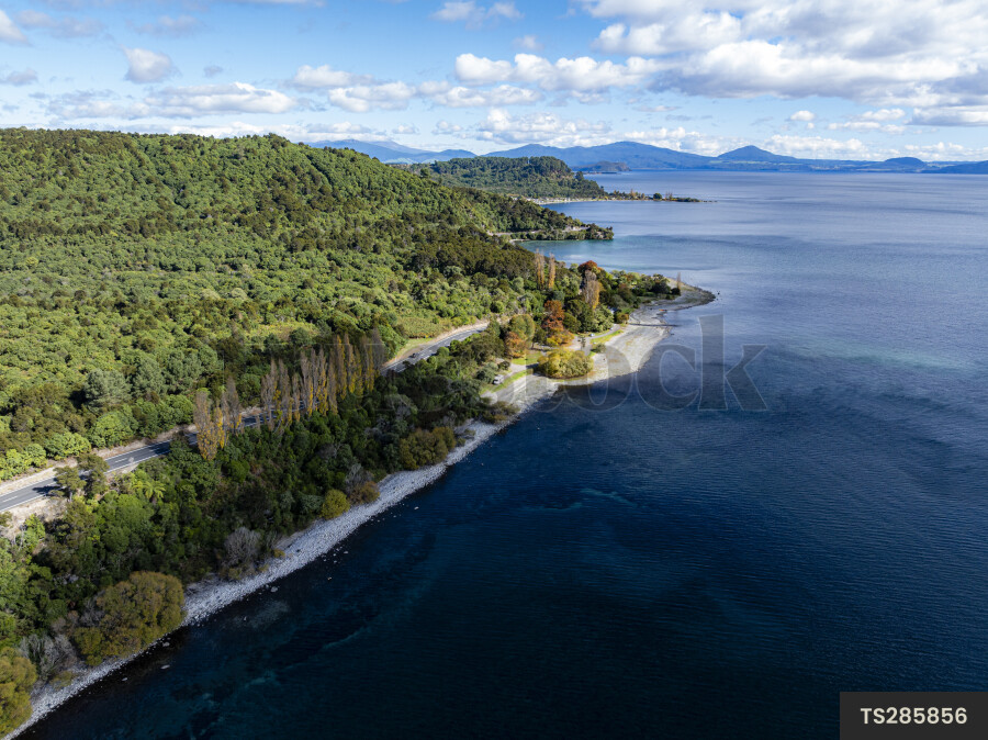 Aerial view of lush mountain range and lake
