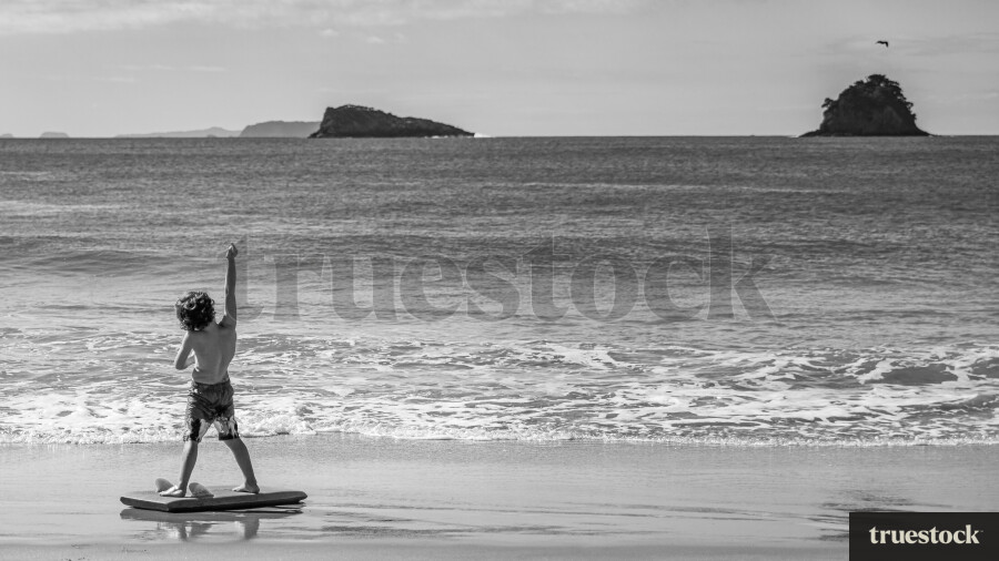 Child on a boogie board at the beach