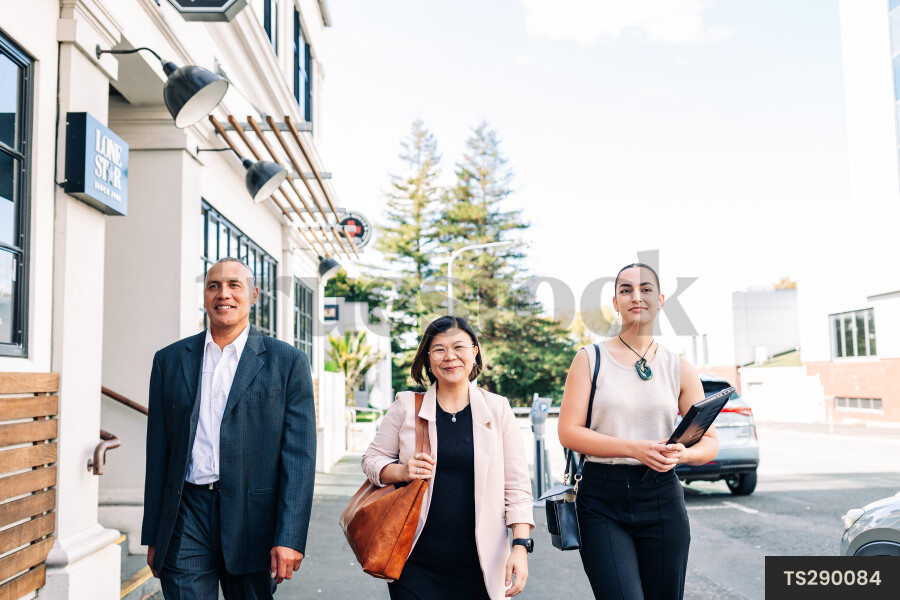 Businesspeople walking on city street