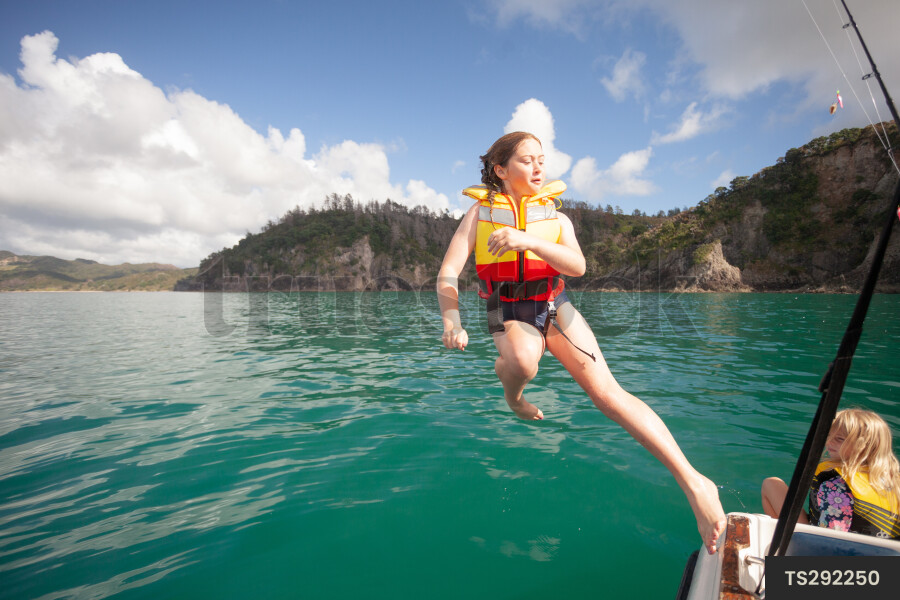 Teen Girl Jumping off Boat by Salena Truestock