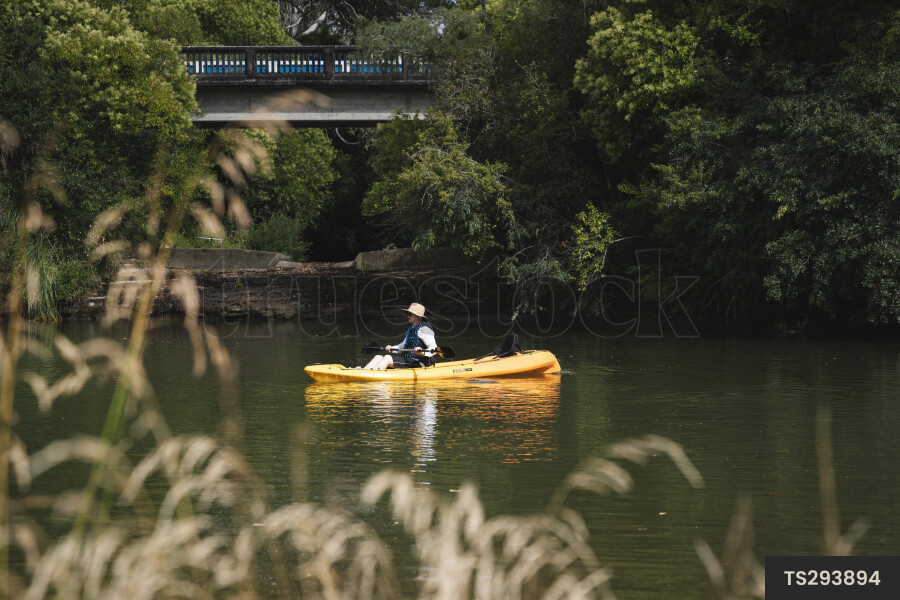 Woman kayaking on river
