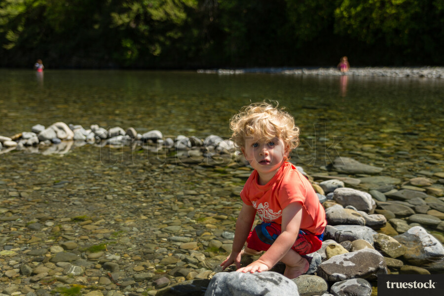 Toddler on the lake rocks