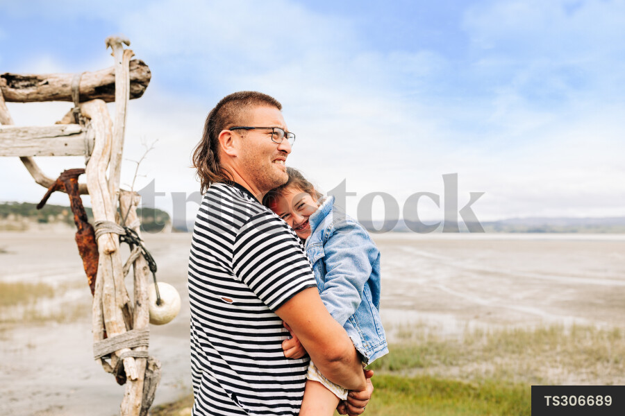 Man and his daughter by beach