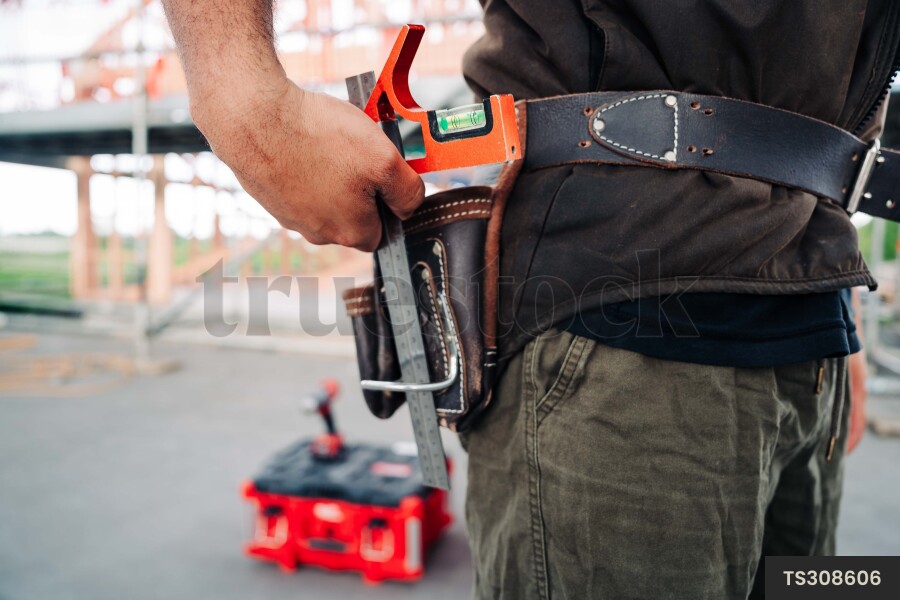 Man with tool belt on construction site