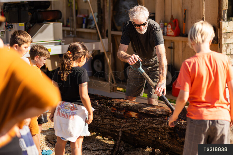 Man Working on Wooden Log