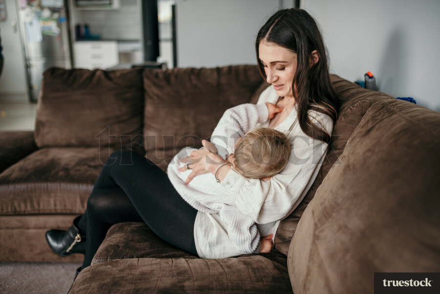 Mother Holding Baby on Couch