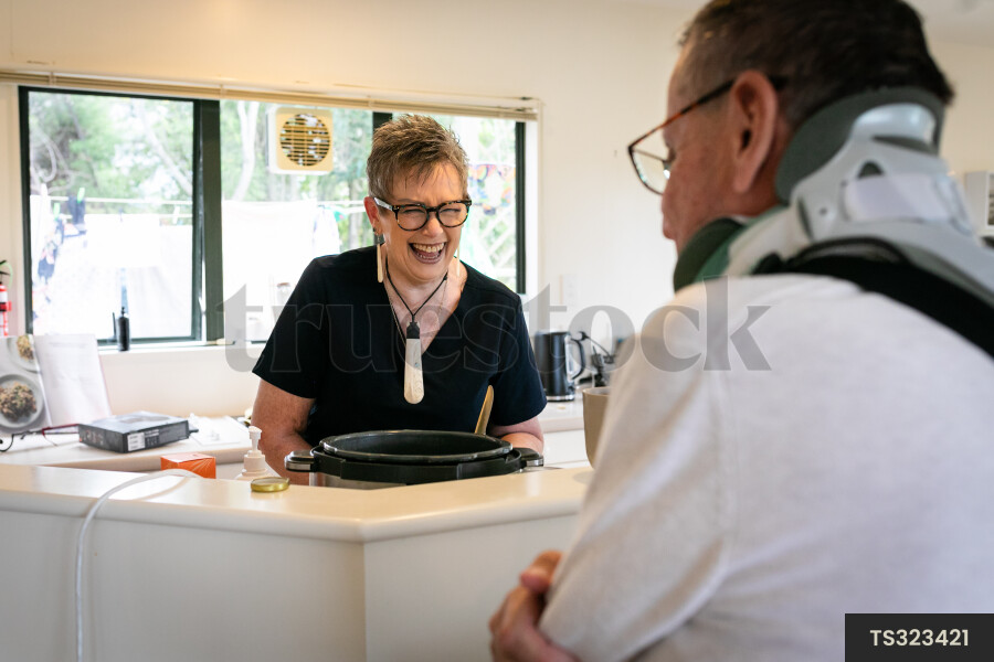 Health carer and patient in kitchen