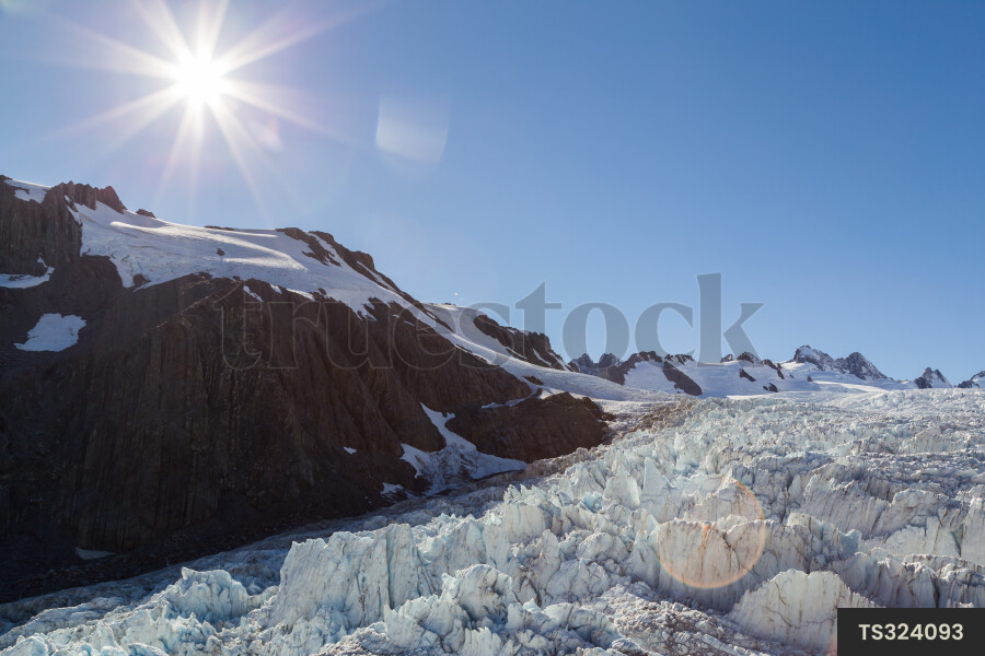 Sun over mountain and glacier