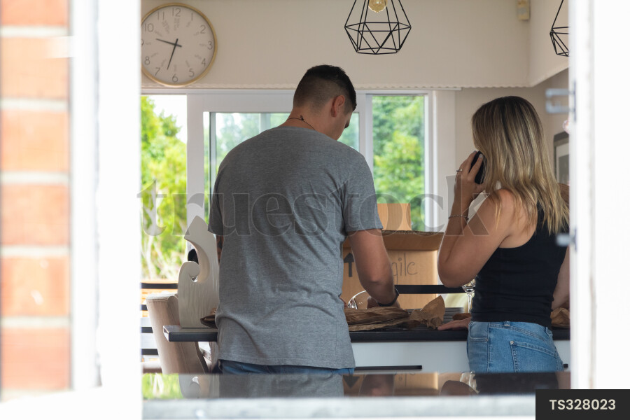Couple packing in kitchen