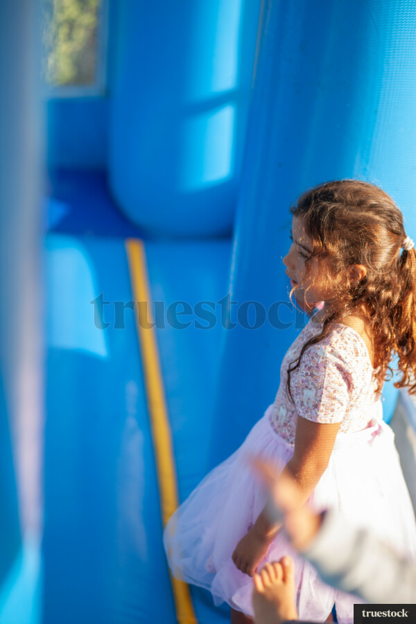 Child climbing and bouncing in the inflatable bouncy castle
