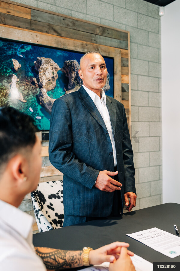 Businessmen talking during meeting in boardroom