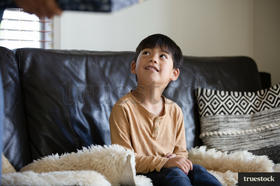 Young Boy Sitting on Couch