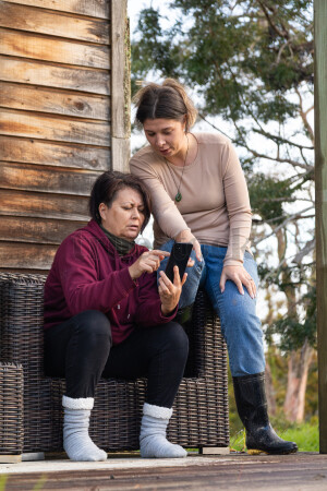 Family Using Phone on Deck