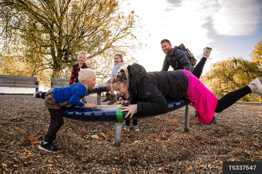 Family playing on playground equipment