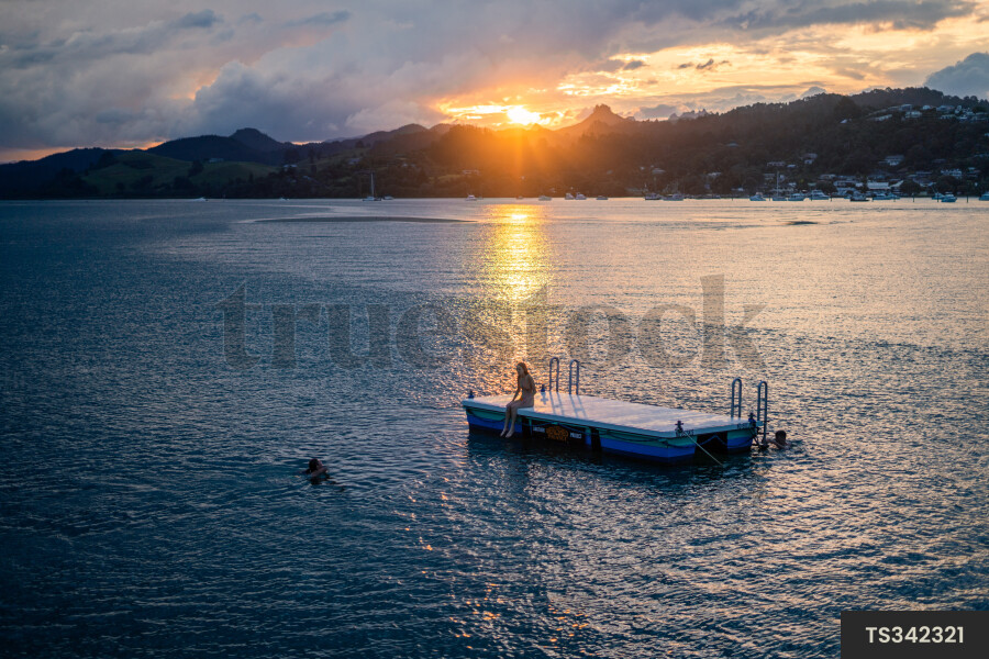 Women Swimming at Sunset