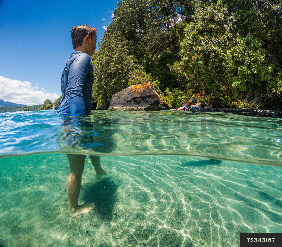 Boy wading in sea