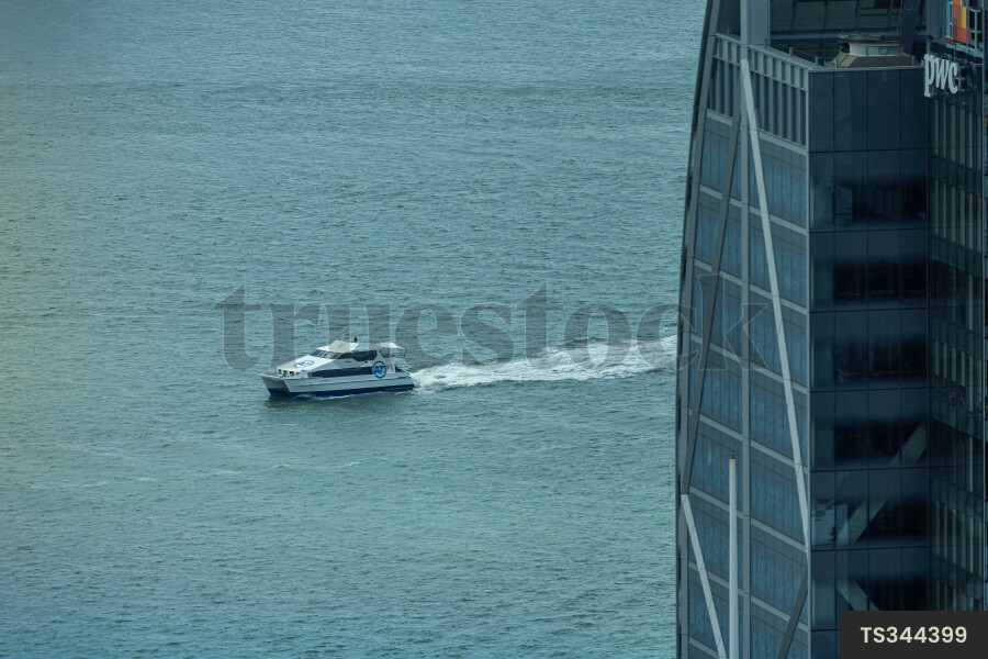 Boat on sea by building in Auckland